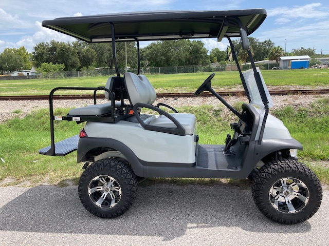 A grey-colored golf cart with 4 passenger seating